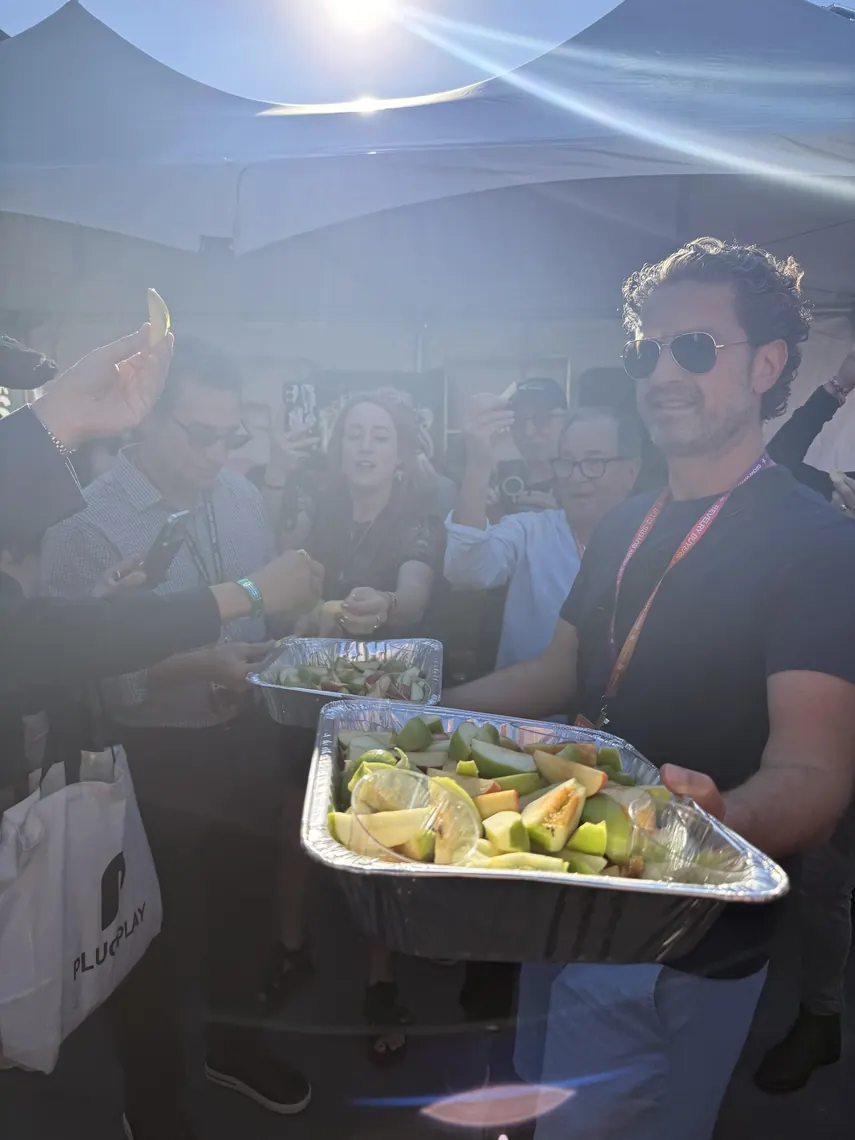 Jordan Isenstadt carrying a tray of apple slices through the crowd