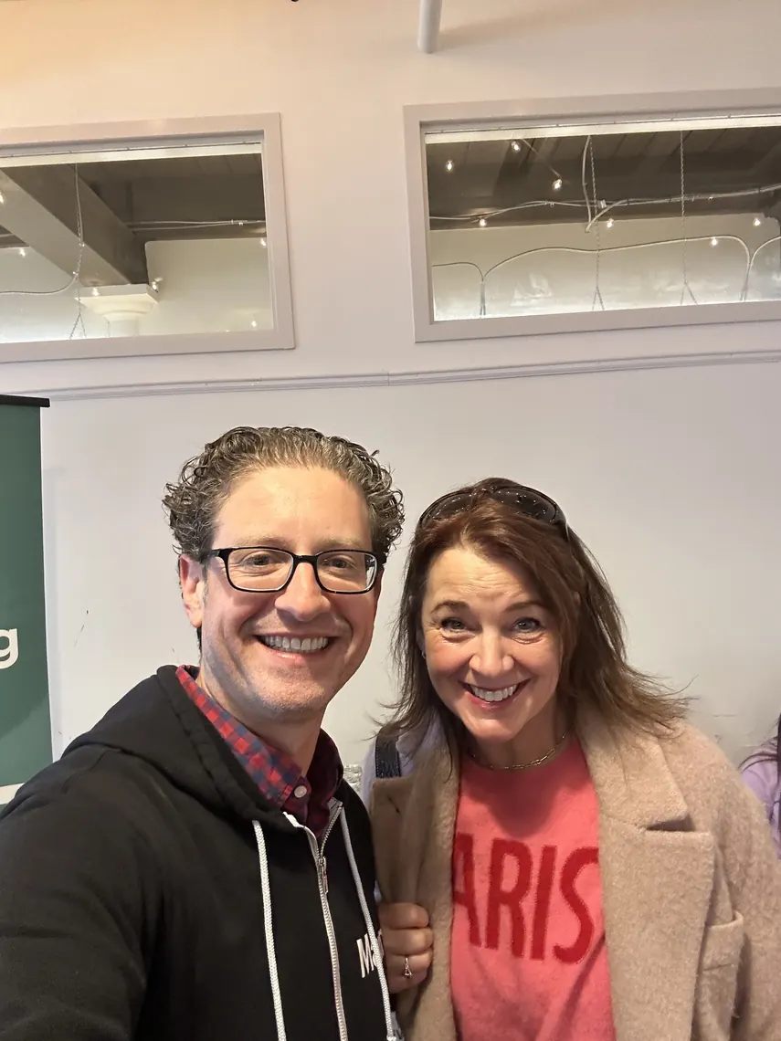 Jordan Isenstadt with a guest in a pink sweater