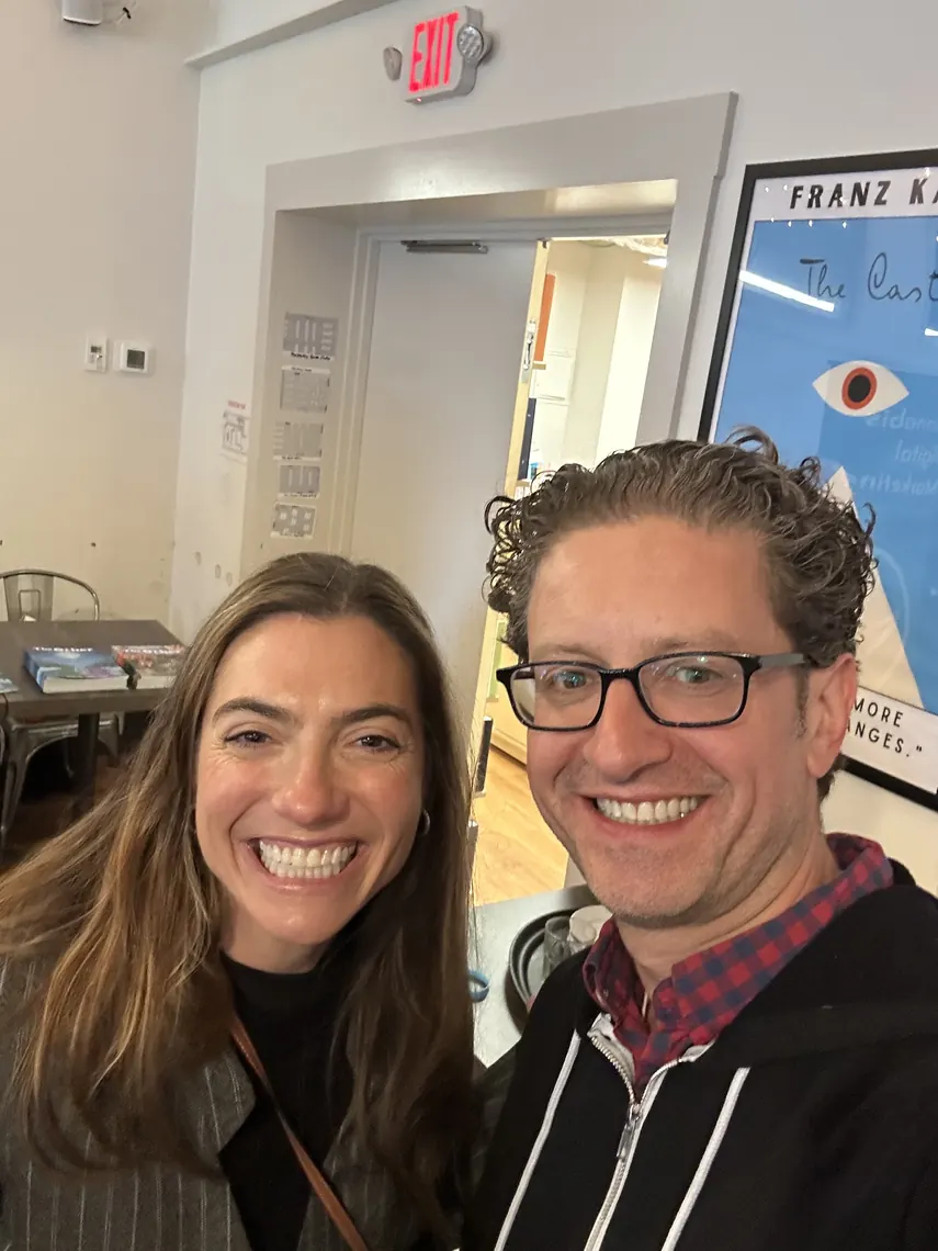 Jordan Isenstadt with a guest by the bookstore entrance