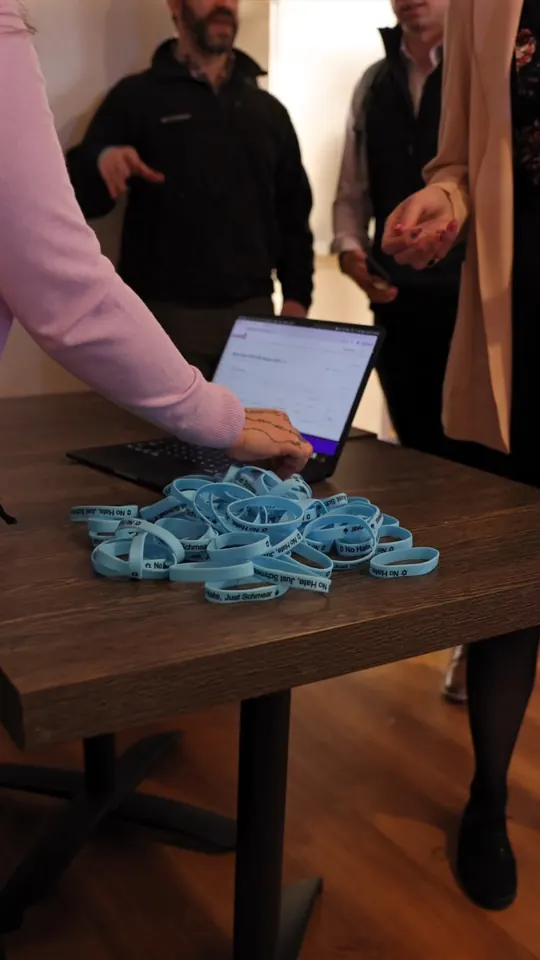 Check-in table with a pile of blue wristbands