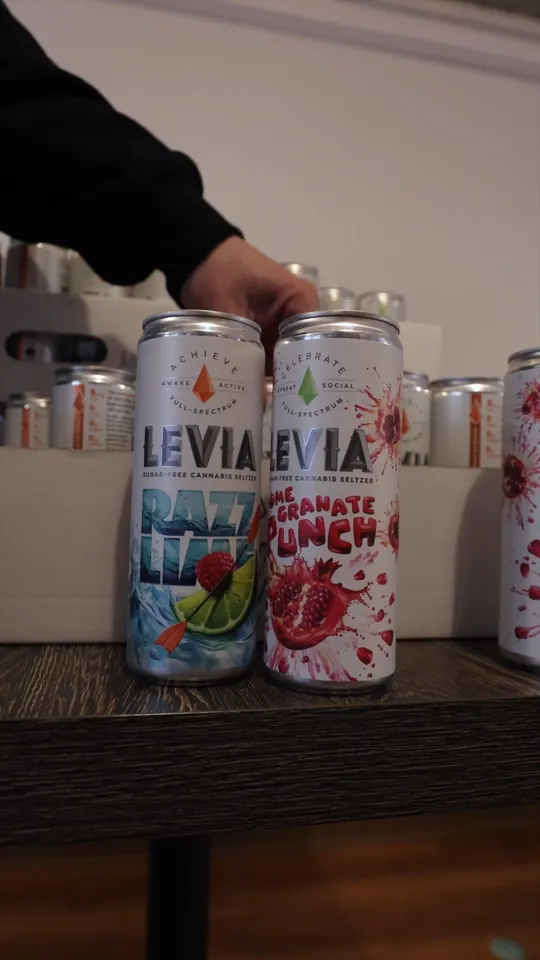 Levia cannabis seltzer cans on a cafe table