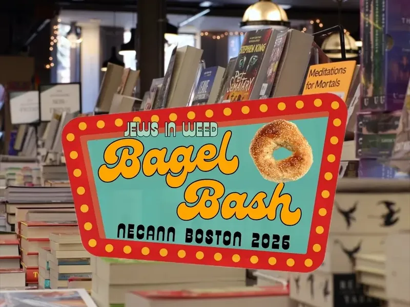 Bagel Bash NECANN Boston 2026 sign over the book displays at Trident Booksellers