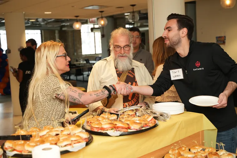 Guests greeting each other over the bagel spread