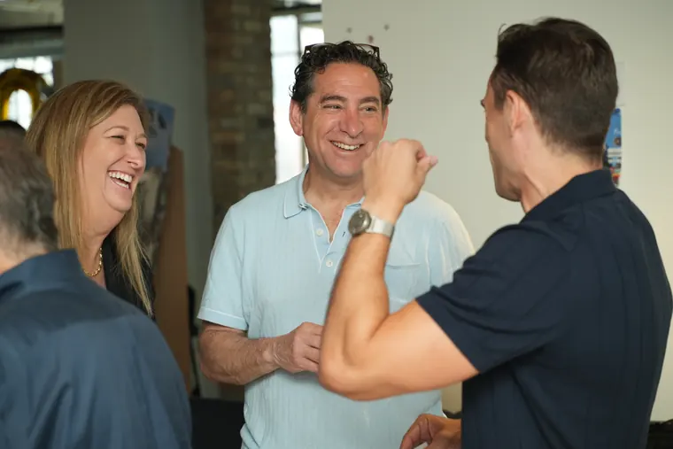 Three attendees laughing together