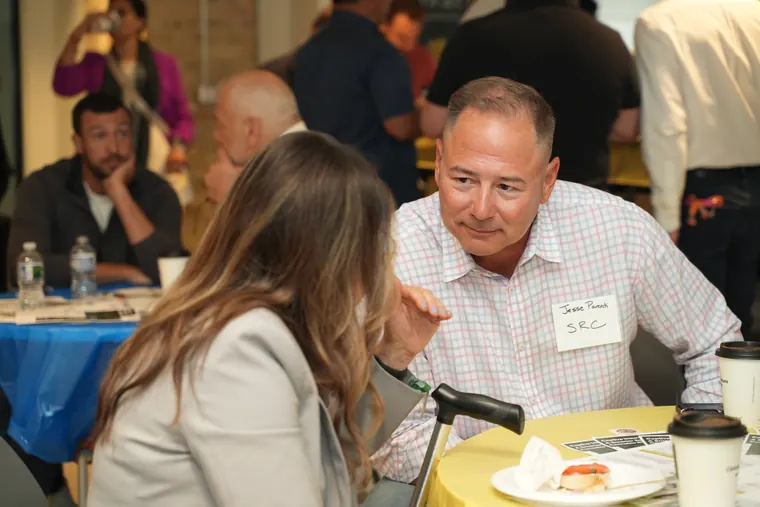 Attendees chatting across a breakfast table