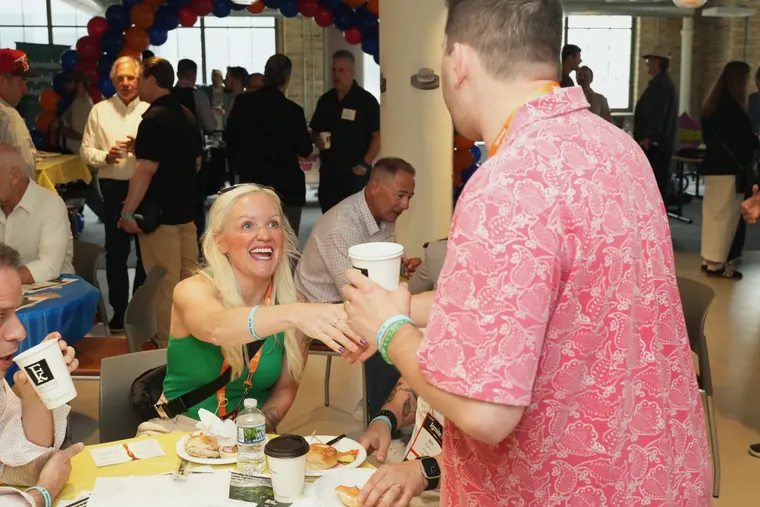 Guest reaching across a breakfast table to shake hands