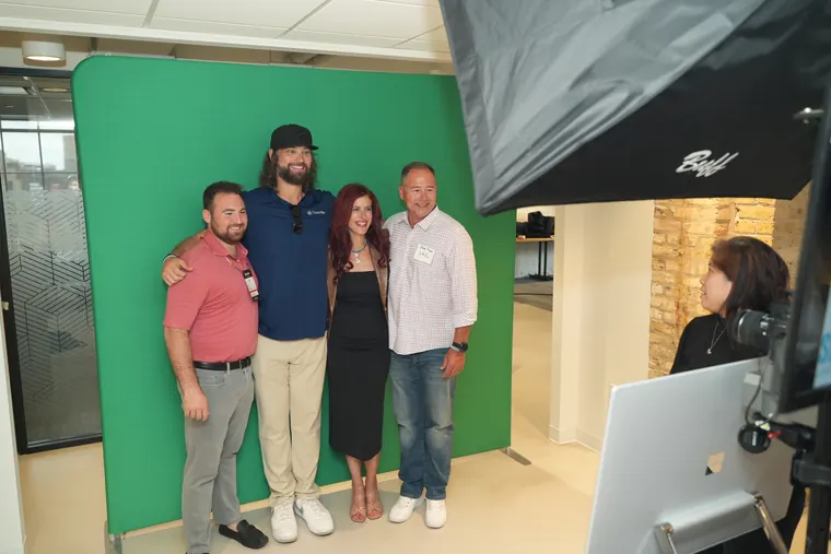 Group posing in front of the green screen photo setup