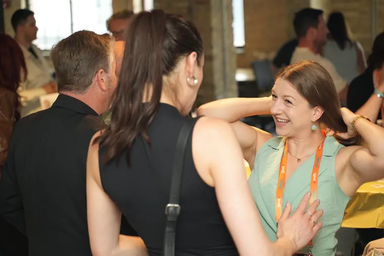 Two attendees laughing together