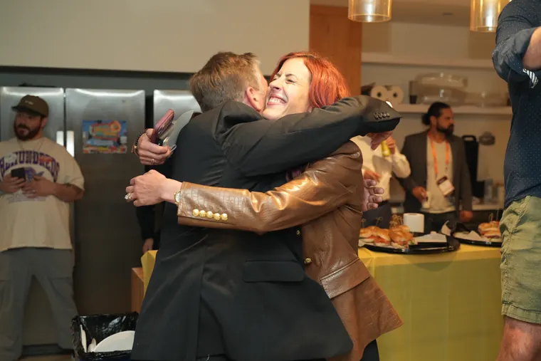 Two attendees hugging