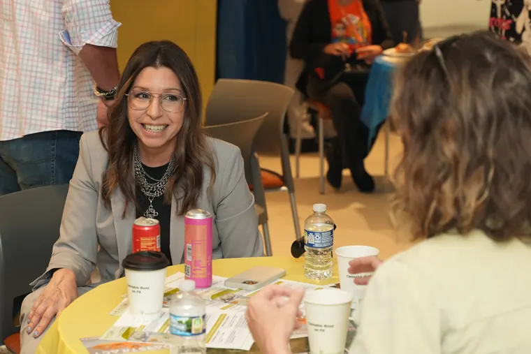 Attendee smiling at a breakfast table