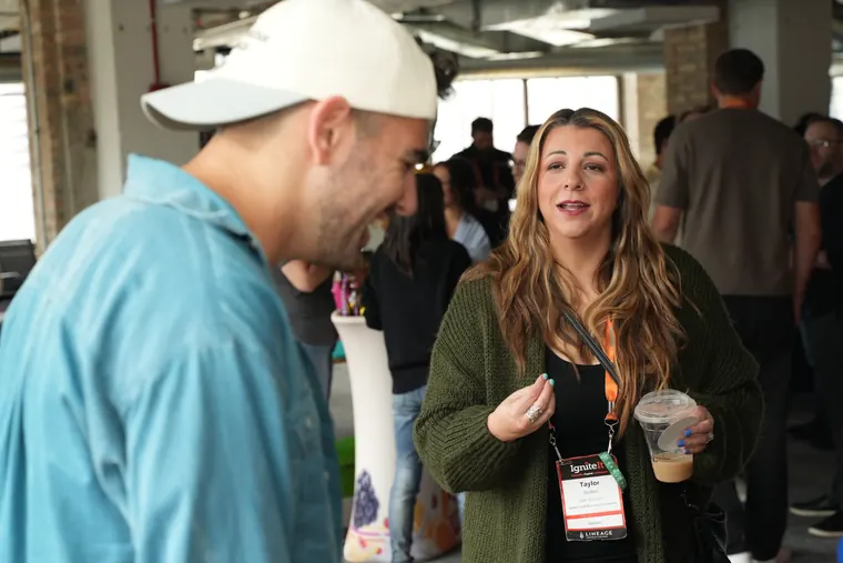 Attendees catching up near the snack table