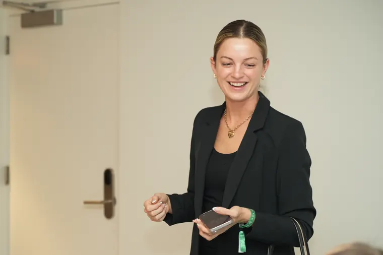 Guest in a black blazer smiling