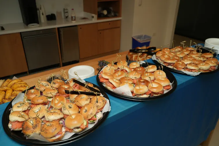 Rows of bagel platters on a blue tablecloth
