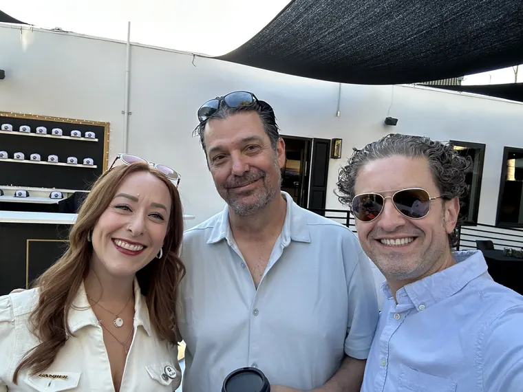 Jordan Isenstadt with two guests in front of the coffee bar