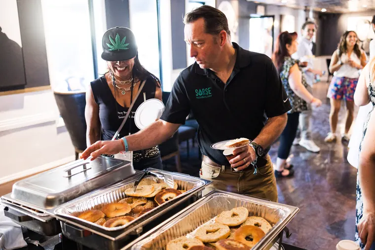 Server refilling chafing dishes of bagels