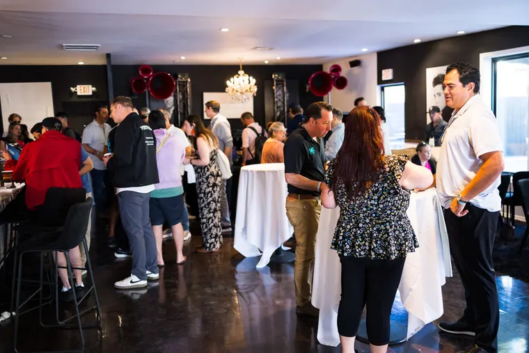 Wide view of guests mingling inside the clubhouse