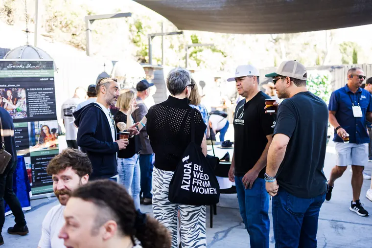 Crowd filling the patio between vendor tables