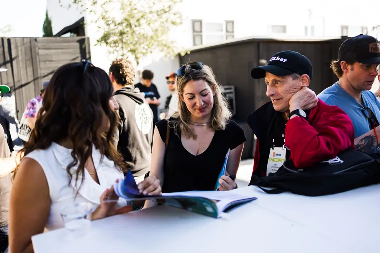 Guests flipping through magazines at a patio table