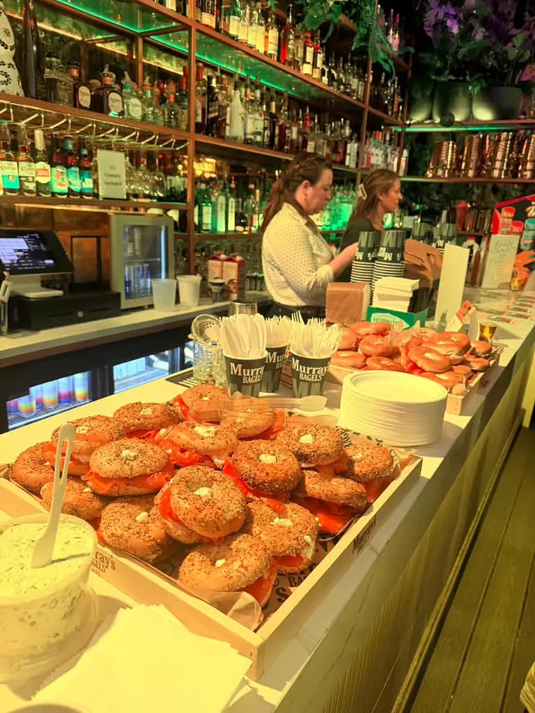 Bar counter lined with trays of bagels at The Delancey Rooftop