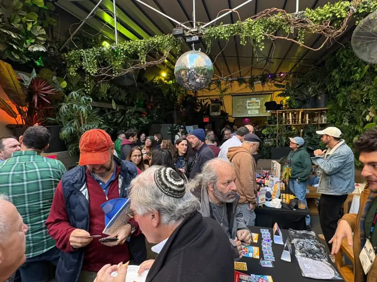 Guests crowding the vendor tables under the disco balls