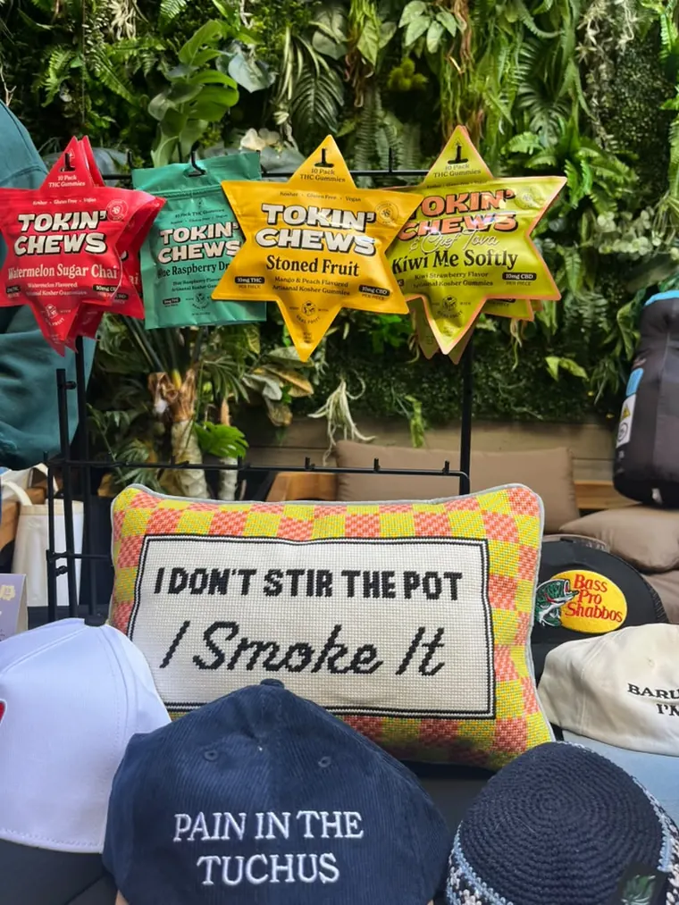 Tokin' Jew table with Tokin' Chews, a Pain in the Tuchus cap and an I Don't Stir the Pot, I Smoke It pillow