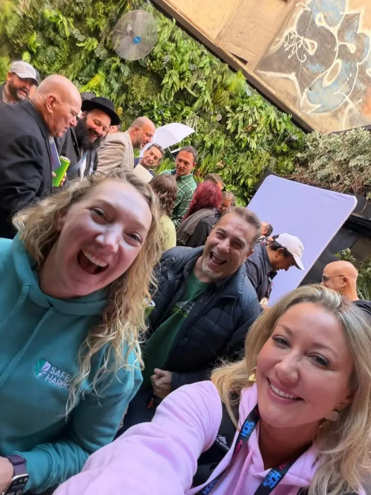 Group selfie with the crowd behind