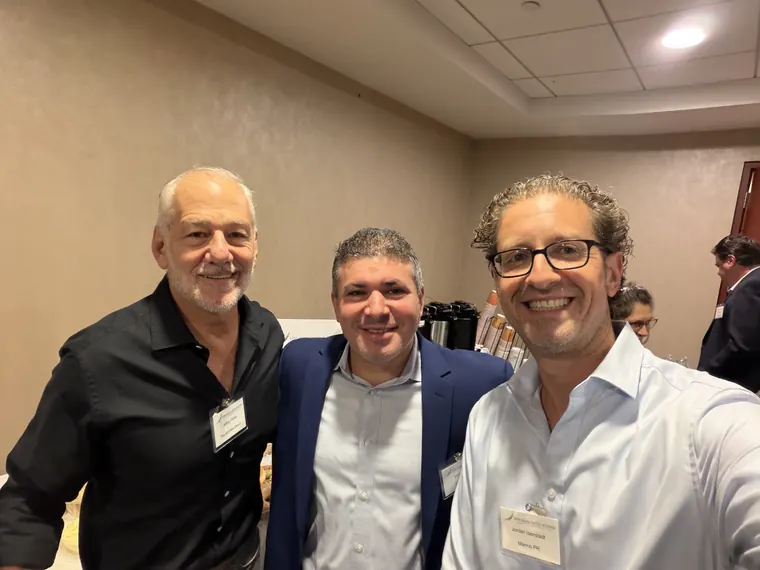 Jordan Isenstadt with two attendees inside the venue