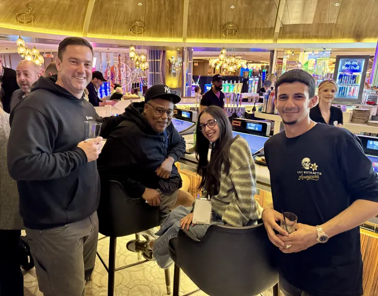 Attendees relaxing at the bar