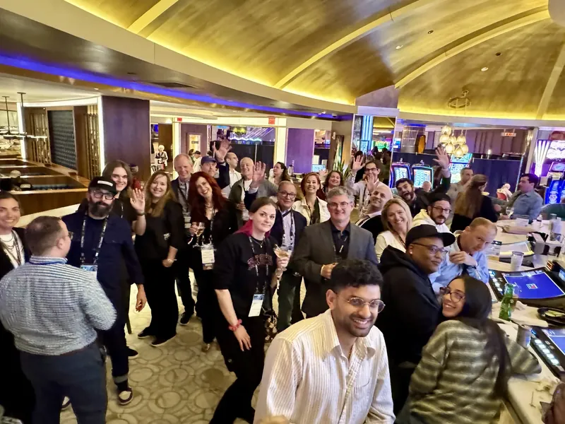 The happy hour crowd waving for a group photo at the Hard Rock's Center Bar