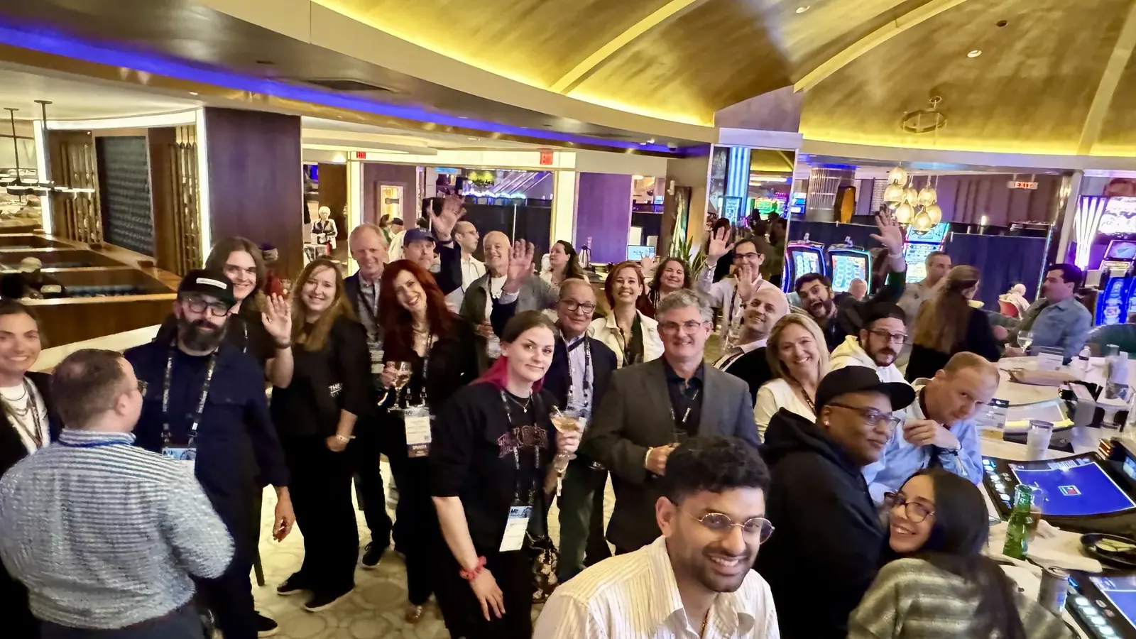 The happy hour crowd waving for a group photo at the Hard Rock's Center Bar