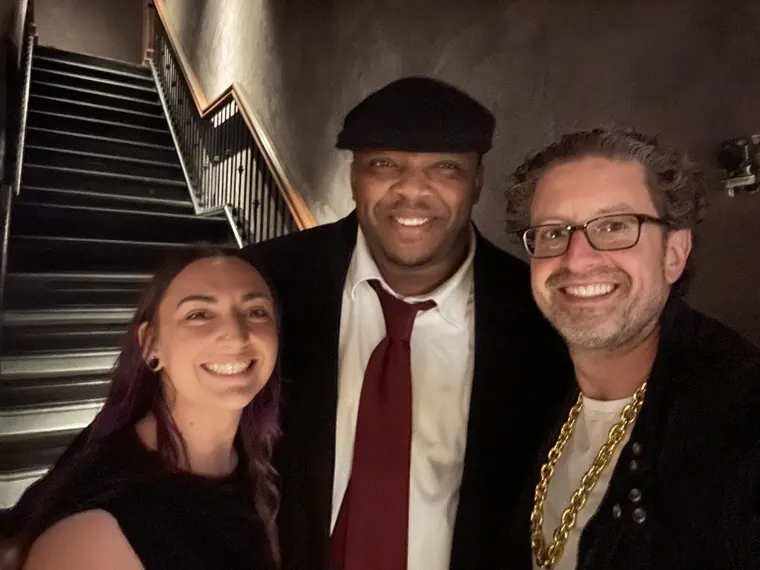 Jordan Isenstadt with two guests by the stairs